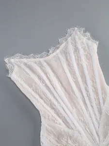 Macro detail view of white lace corset bodice with boning and eyelash lace trim.