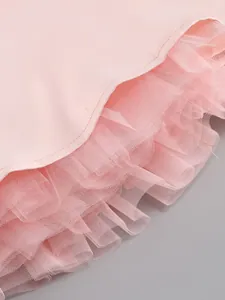 Close-up detail of the layered pink mesh lining on a fluffy summer party dress hemline