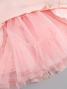 Detailed macro shot of pink layered tulle mesh lining with ruffled hem for a tutu dress