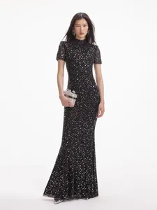 Detailed view of black fishtail evening gown with shimmering silver rhinestone accents