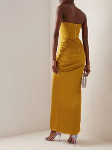 Back view of a mustard yellow strapless satin maxi dress with ruching details