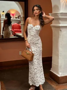 Elegant white lace spaghetti strap maxi dress with hollow out floral patterns for women