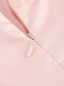 Close-up view of the smooth invisible zipper detail on a elegant pink satin dress