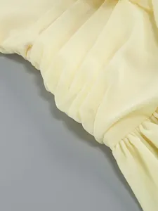 Detail of light yellow ruched fabric with elegant pleats and soft texture