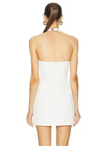 Detailed back view of a white halter-neck mini dress with elegant metal buckle neck decoration.