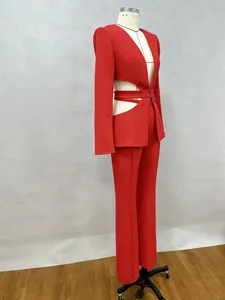 Side view detail of a red two-piece suit with hollow waist blazer and wide-leg trousers
