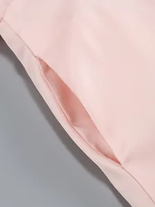 Detailed macro view showing the side pocket construction on a pink high-end dress