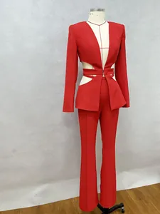 Elegant red two-piece suit with V-neck cut-out blazer and flared trousers on mannequin