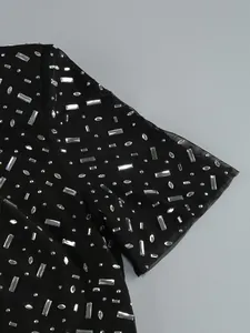 Macro detail of silver rectangular rhinestones on black mesh fabric for evening gowns