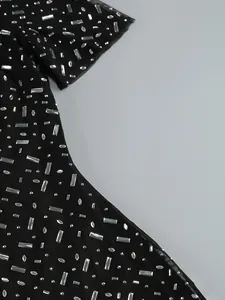 Macro detail showing silver rectangular and round rhinestones on black mesh evening dress fabric