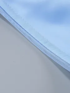 Close-up macro view of light blue mesh lining and fine stitching on elegant summer dress
