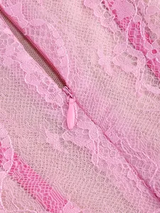 Close-up macro detail of the invisible zipper on an elegant pink floral lace evening gown