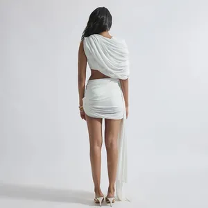 Vista posterior detallada de un conjunto blanco de dos piezas con top chal y minifalda fruncida