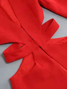 Close-up of waist cutout and stitching detail on elegant red blazer jumpsuit set