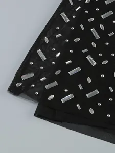 Close-up detail of black mesh evening gown with sparkling clear rhinestone embellishments