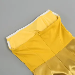 Close-up of yellow and gold formal dress back detail with invisible zipper closure.