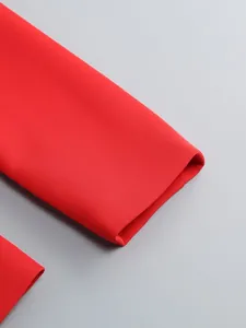 Macro detail of high-quality red suit jacket sleeve cuff showing stitching