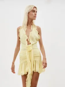 Elegant pale yellow halter dress featuring ruffles, 3D flowers and ruched details