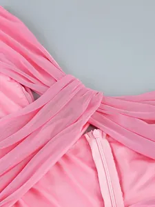 Detail of pink mesh evening dress featuring elegant front twist knot and zipper