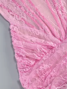 Close-up detail showing the delicate pink lace and soft feather trim on a dress.