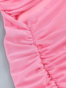 Macro view showing the detailed ruched texture of high-end pink mesh fabric on a sexy dress