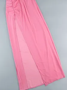 Detail view of pink pleated maxi dress with sexy high slit and ruched texture