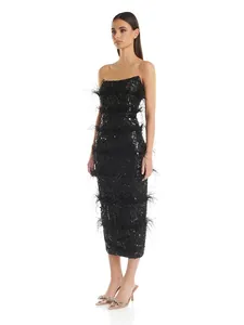 Full view of elegant black strapless sequin midi dress with ostrich feather trim layers