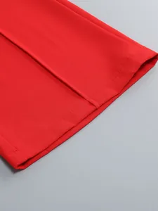 Close-up of vibrant red wide-leg trouser hem showing fine stitching and fabric texture
