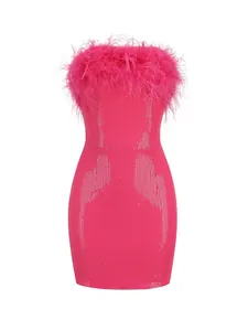 Primer plano de las lentejuelas rosa vibrante y el ribete de plumas de avestruz en el vestido mini