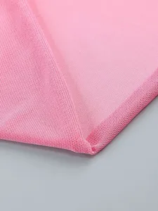 Close-up detail of high-quality pink knitted fabric showing texture and hem finish