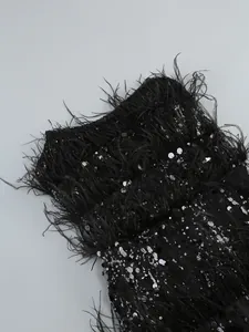 Detailed view of the exquisite black sequins and ostrich feather fringe on a cocktail dress