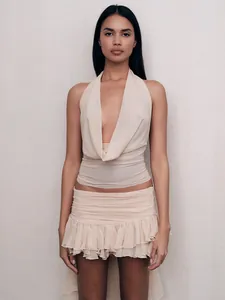 Elegant cream halter neck crop top and ruffled mini skirt two-piece set for women
