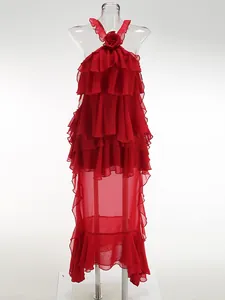 Detail of red tiered ruffle halter maxi dress featuring elegant 3D flower decoration.