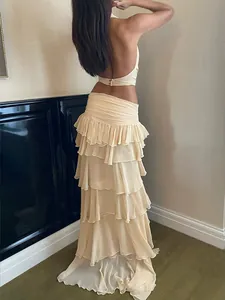 Back view detail showing the ruffled texture of the cream halter top and tiered maxi skirt set.