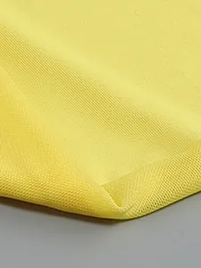Detailed macro view of high-quality lemon yellow textured fabric for formal dress