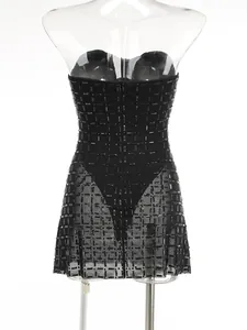 Detailed view of the heavy black beading and mesh panels on a strapless mini dress