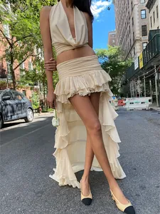Elegant beige two-piece set featuring a sexy halter top and ruffled high-low hem skirt.