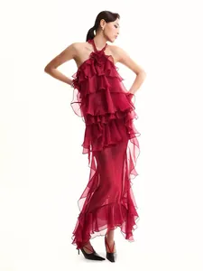 Close-up of burgundy tiered ruffle halter dress with floral detail and sheer skirt