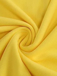 A macro detail view of vibrant yellow mesh fabric featuring soft folds and elegant texture