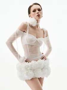 Elegant white two-piece set featuring sheer long sleeve top and 3D floral bubble skirt.