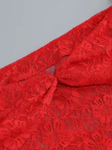 Detailed close-up showing the intricate red floral lace pattern of an evening top