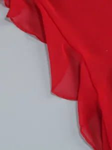 Close-up macro detail of red sheer chiffon ruffle hem with fine overlock stitching