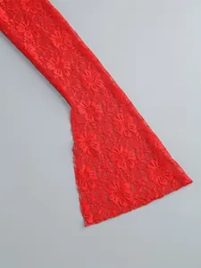 Close-up detail of exquisite red floral lace texture on flared sleeve of evening dress