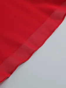 Close-up showing the delicate red sheer fabric and hemline of a sexy ruffle maxi dress