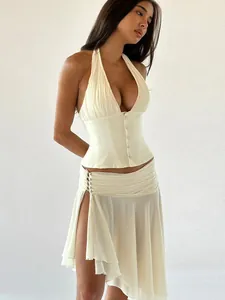 Elegant ivory two-piece fashion set with pleated halter top and asymmetric mesh slit skirt