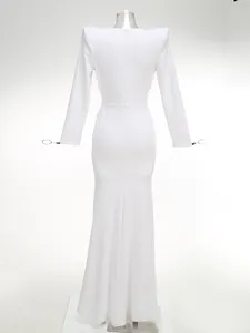 Elegant white long-sleeved maxi dress featuring a structured back view on mannequin