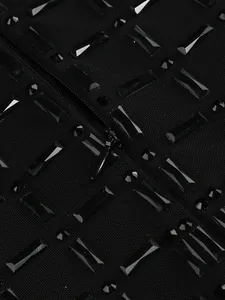 Detailed view of heavy rhinestone embellishments on black mesh fabric with zipper.
