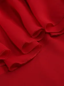 Detailed close-up of elegant red layered ruffle hem on a lightweight chiffon maxi dress.