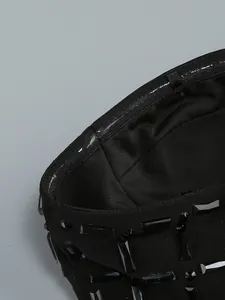 Detailed view of the non-slip silicone strip on a black rhinestone embellished tube dress