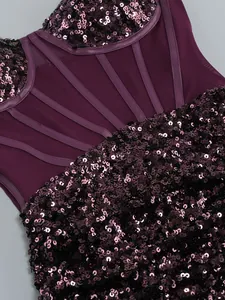 Close-up macro view of the purple sequins and sheer mesh panels on this formal evening dress.